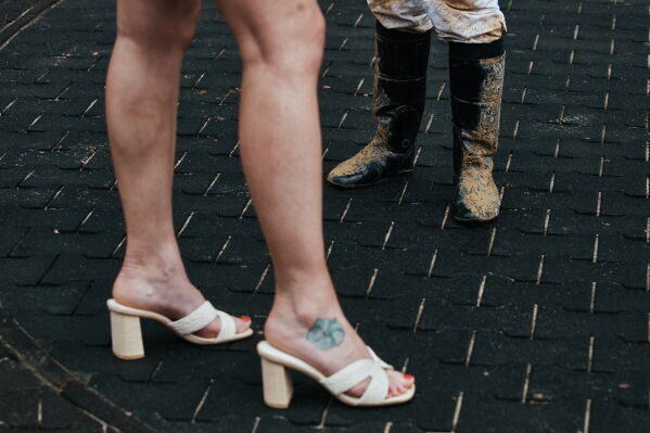 A journalist interviews a Jockey inside the paddock at Aqueduct Racetrack in the Queens borough of New York, Saturday, June 27, 2026. (AP Photo/Andres Kudacki)