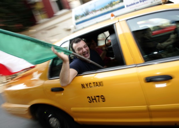 An Italy fan celebrates from a taxi in Soho after their win over France in the 2006 World Cup on July 9, 2006.