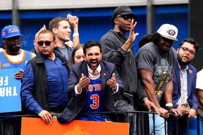 Group of excited sports fans at an outdoor event, one wearing a basketball jersey and passionately cheering