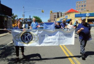 The Sunnyside Kiwanis marched behind their banner.