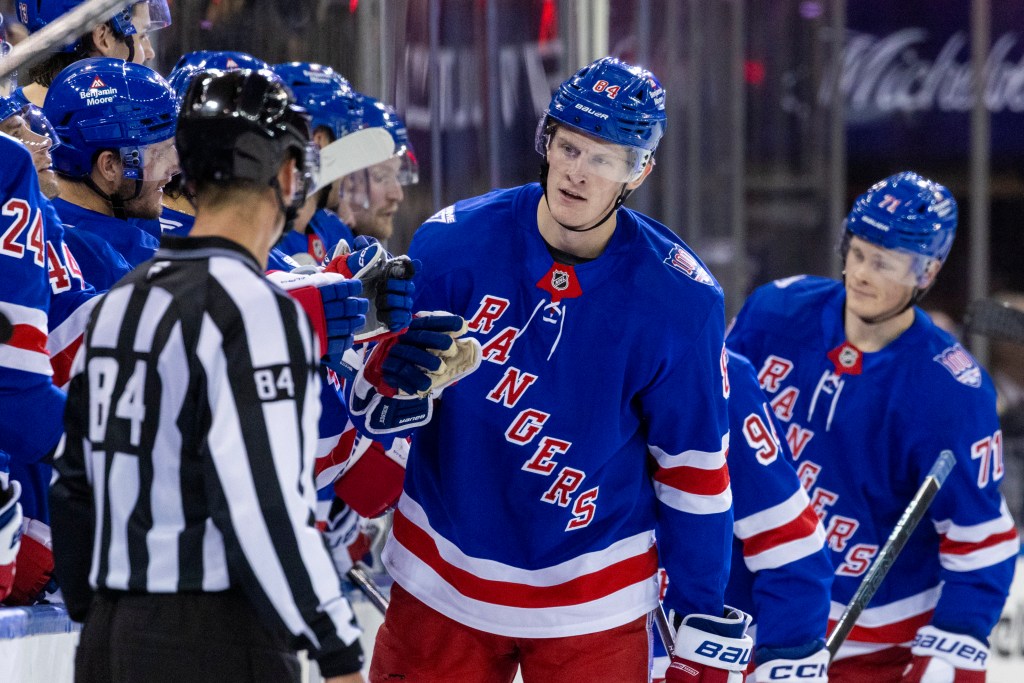 New York Rangers center Adam Edstrom (84) celebrates his goal with the team in the second period against the New Jersey Devils at Madison Square Garden, Thursday, Oct. 2, 2025, in New York, NY. 