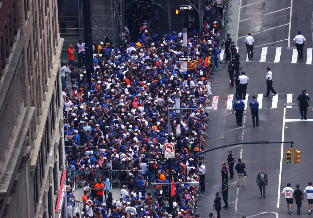 Aerial view of New York Knicks fans gathered for a parade, with police officers on duty.