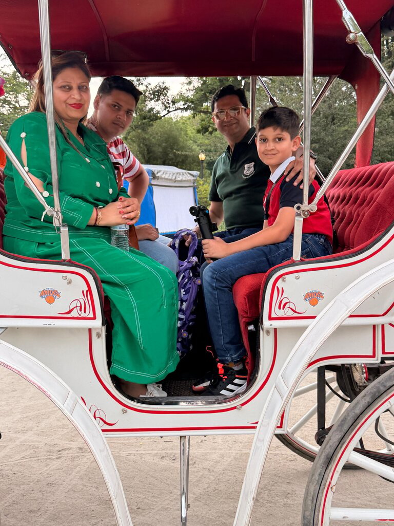 Romanch Mahajan and his family in a Central Park horse carriage.