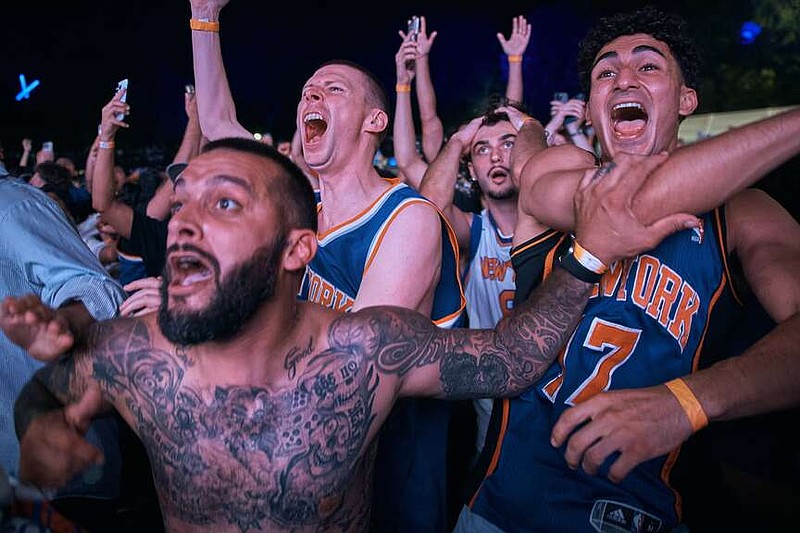 New York Knicks fans celebrate their victory after a watch party for Game 5 of the NBA Finals basketball series against the San Antonio Spurs, Saturday, June 13, 2026, in New York. (AP Photo/Andres Kudacki)