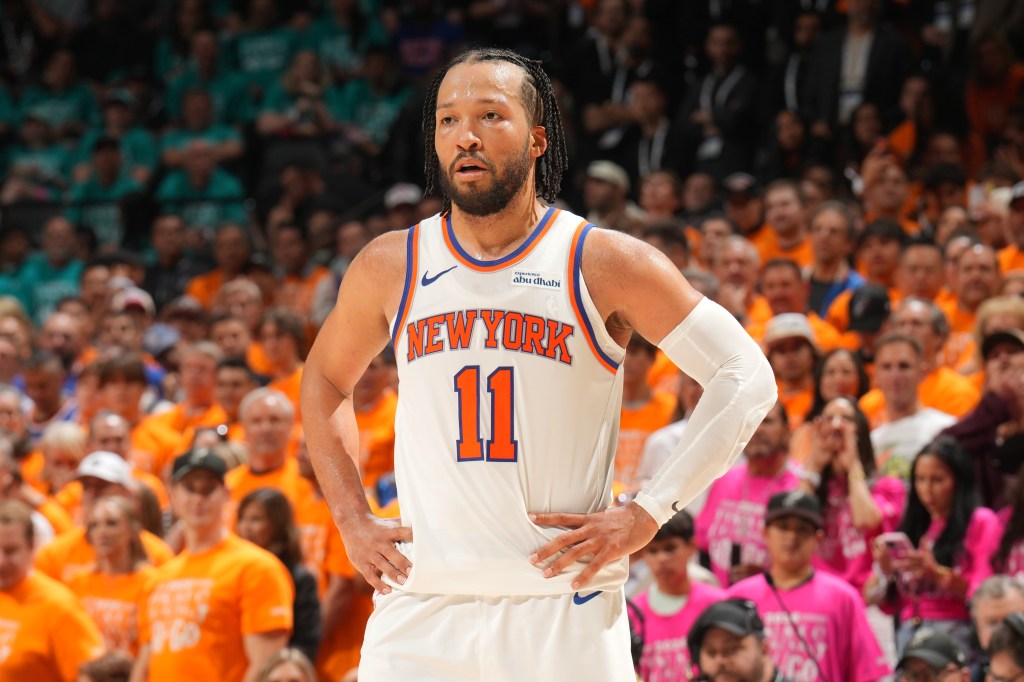 New York Knicks player Jalen Brunson wearing number 11 in a white jersey with hands on his hips.