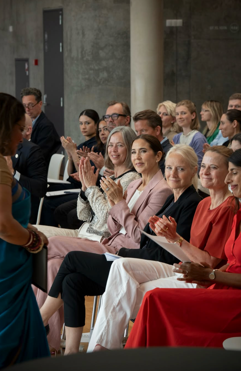Queen Mary looked effortlessly elegant in a dusty rose tailored suit as she attended a women's health symposium in Copenhagen.