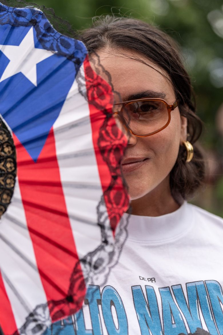 The Puerto Rican flag transforms into the ultimate accessory for the celebratory weekend. Here, a festival-goer carries a flag-emblazoned fan.