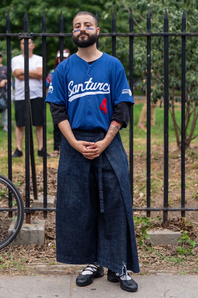 Abdiel attends the Puerto Rican Day celebration in a Santurce baseball jersey layered with a denim wrap skirt.