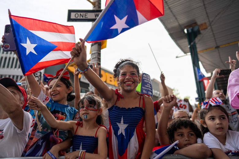 Children wave flags in the crowd in Bushwick.