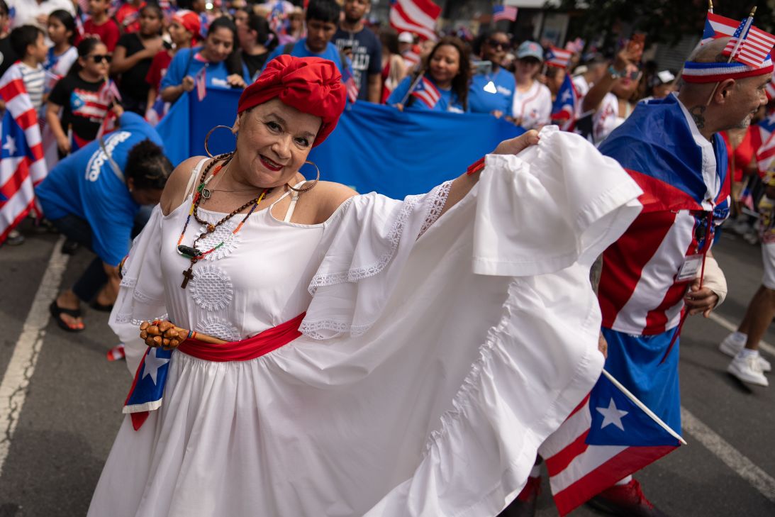 A dancer poses in the street during the annual Knickerbocker Avenue Puerto Rican Day Parade.