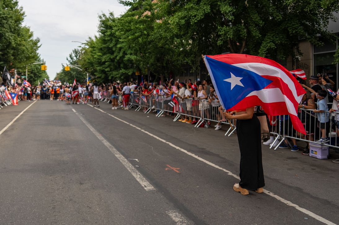 An onlooker takes in the Puerto Rican Day Parade in Bushwick, Brooklyn.
