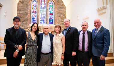 Speakers and honorees in Ascension Hall at the North Brooklyn Angels 6th annual luncheon; from left to right: Paul Samulski, Kendra Chiu, Joseph Lentol, Elaine Brodsky, William Lynn, Neil Sheehan and Eddie Christian. Photo: Julie Thompson/Brooklyn Eagle
