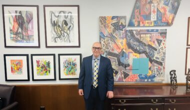 Judge Montelione alongside some of the many pieces of artwork in his office. Photo: Wayne Daren Schneiderman/Brooklyn Eagle