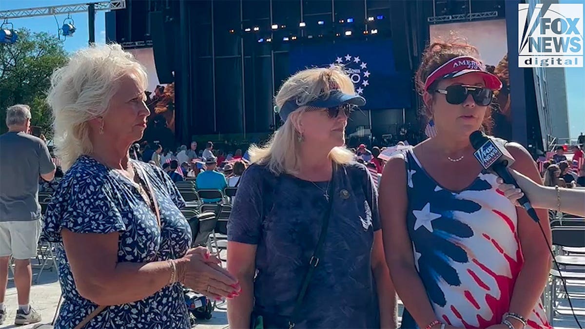 Three women in USA clothes talking to Fox reporter