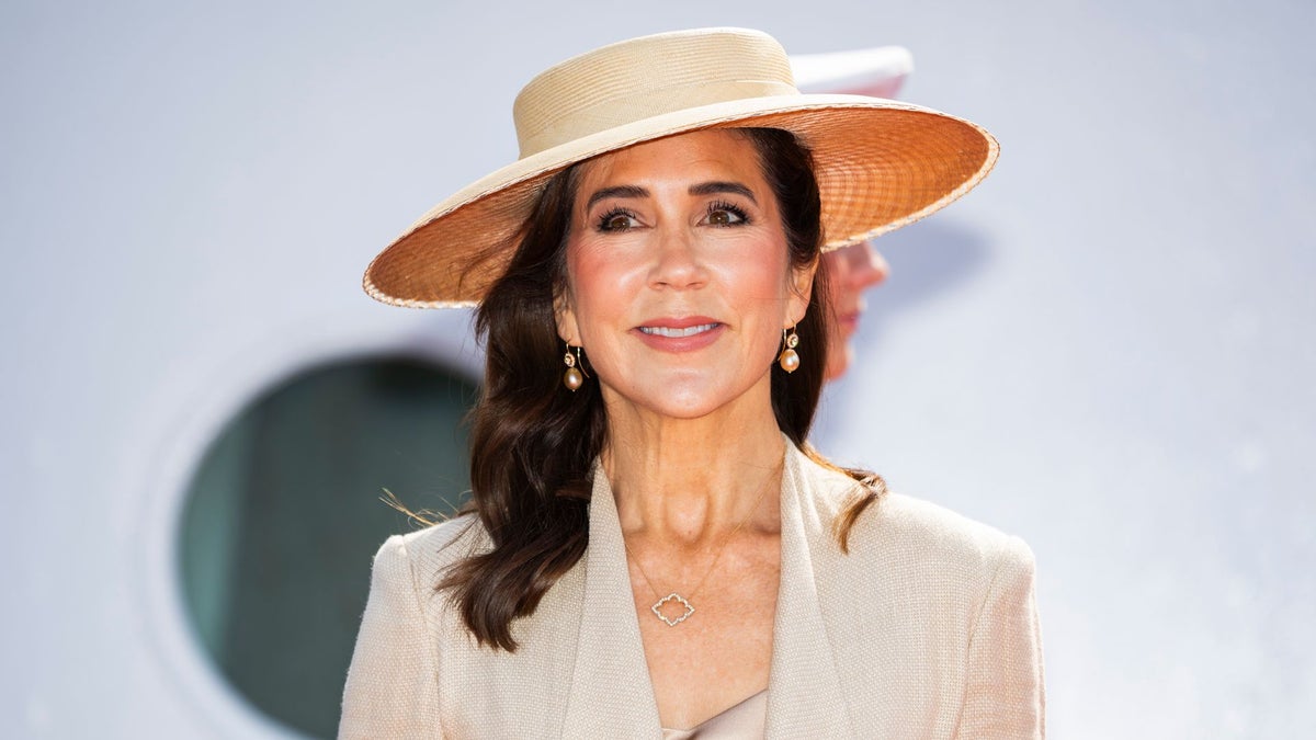 Queen Mary turns heads in a bold printed skirt and dazzling drop earrings during outing with King Frederik