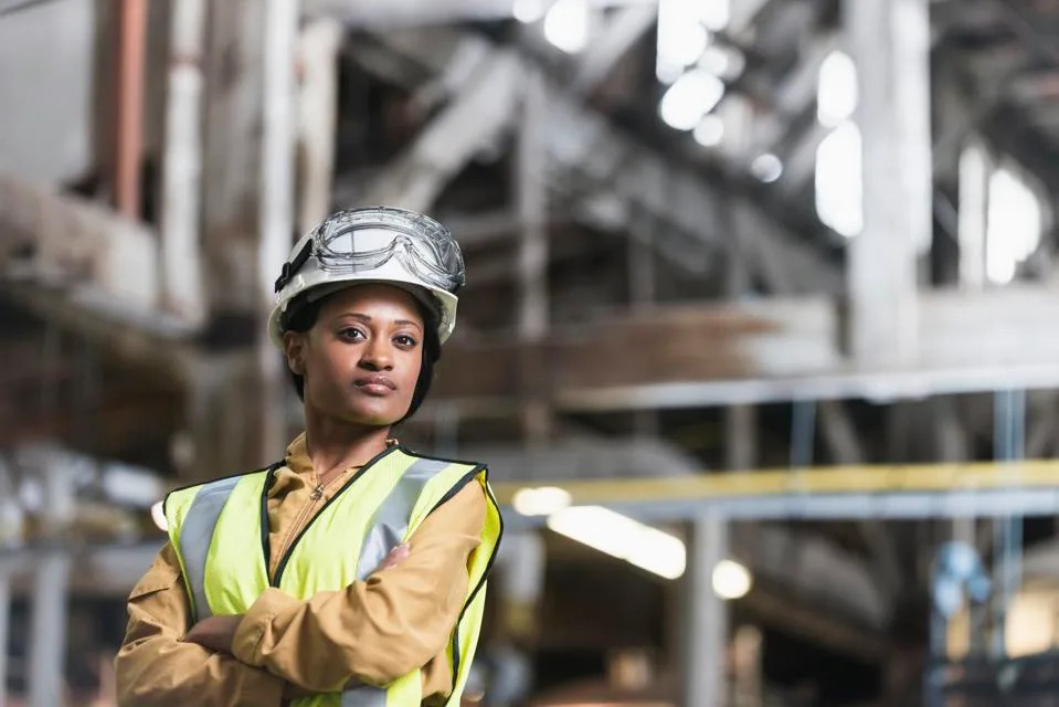 African American woman wearing hardhat and safety vest