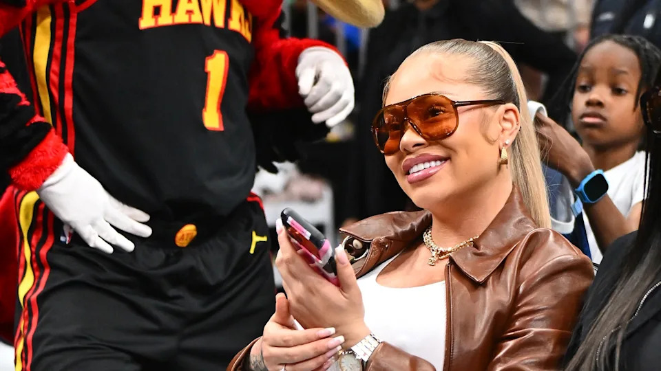 ATLANTA, GEORGIA - MARCH 21: Rapper Latto attends the game between the Golden State Warriors and the Atlanta Hawks at State Farm Arena on March 21, 2026 in Atlanta, Georgia.