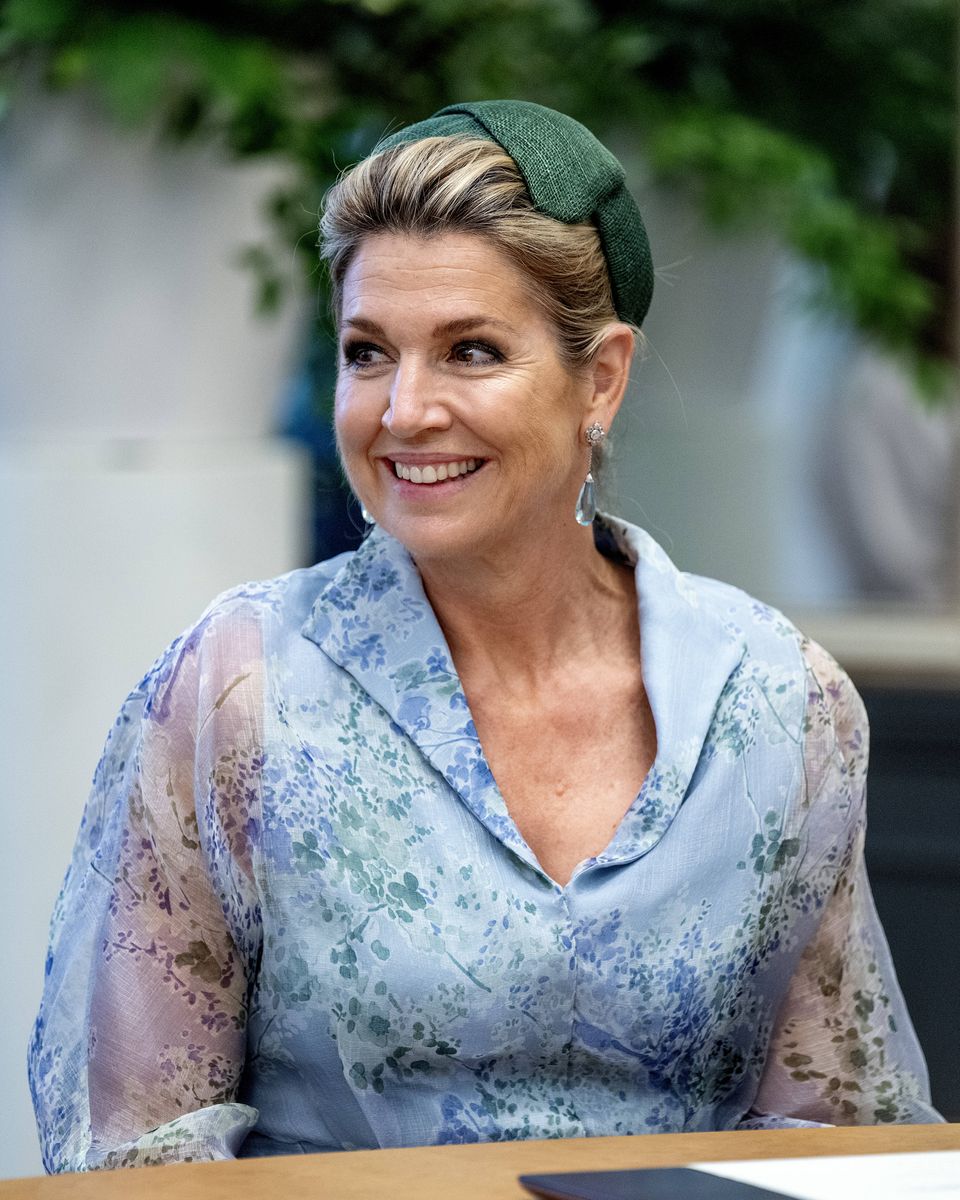 Queen Máxima completed her sophisticated floral look with emerald green accessories and a matching fascinator.