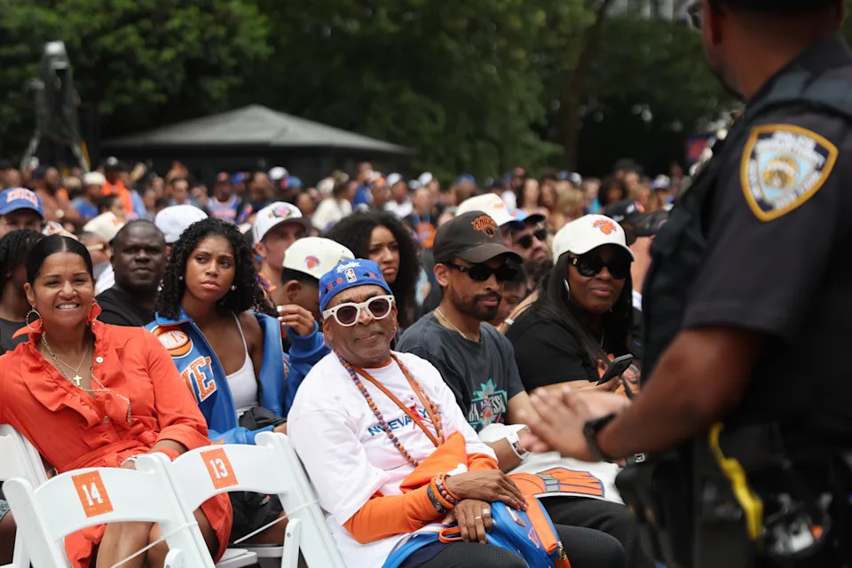 Spike Lee sits before the championship rally at City Hall.