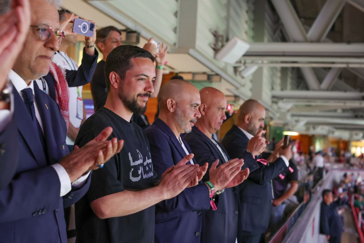 Crown Prince Hussein applauds Jordan's performance alongside fellow supporters during the Group J clash against Austria.