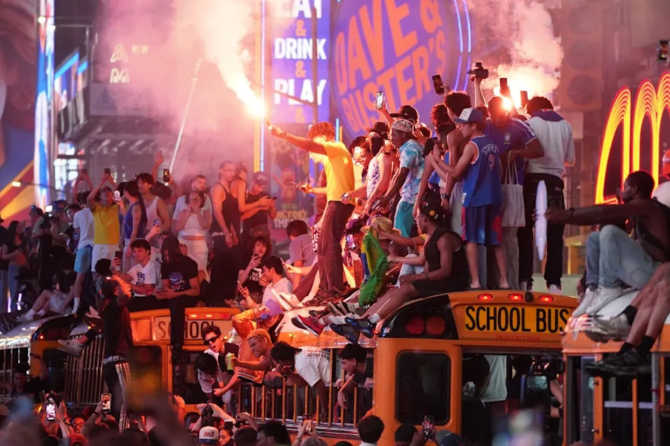 A crowd of people climbs on top of a school bus as Knicks Fans celebrate the team’s NBA Championship on June 13, 2026. Christopher Sadowski for NY Post