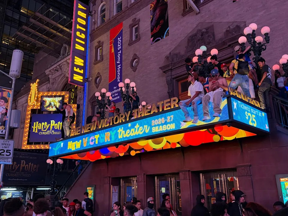 Knicks fans perched on the New Victory Theater after the historic win. Jennifer Bain