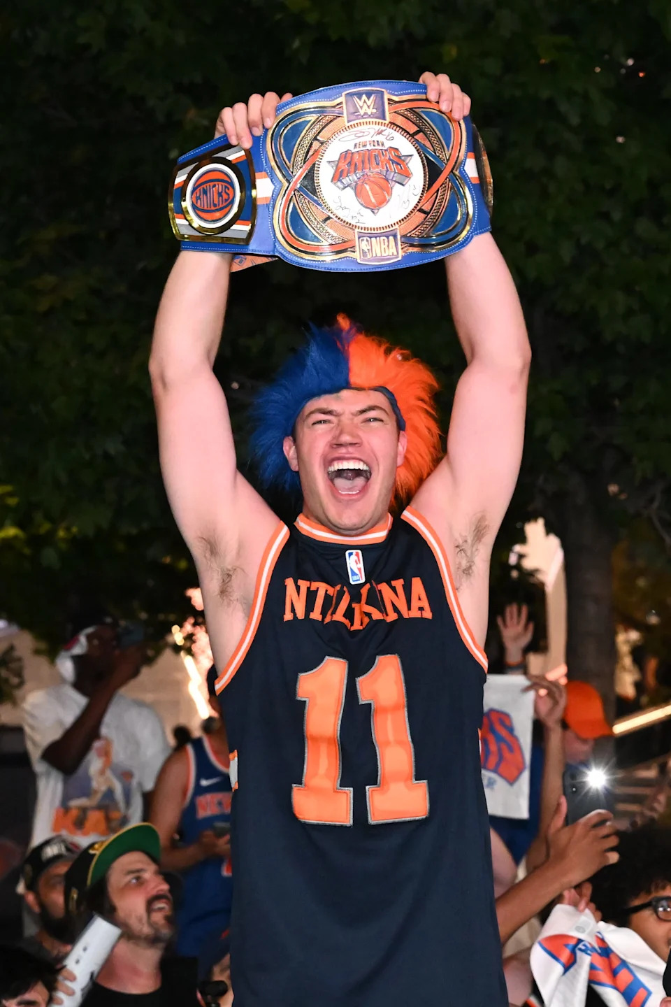 A New York Knicks fan holds up a WWE New York Knicks belt.