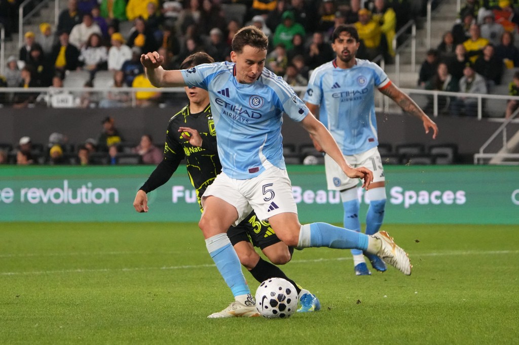 Kai Trewin of New York City FC defends the ball against Hugo Picard of Columbus Crew during a soccer match.