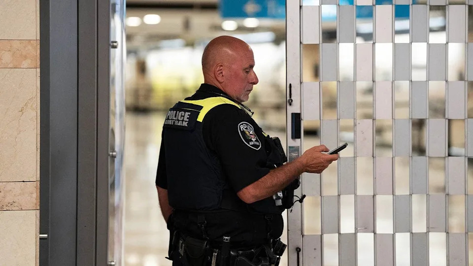 An Amtrak police officer stands near the scene of a stabbing in Penn Station