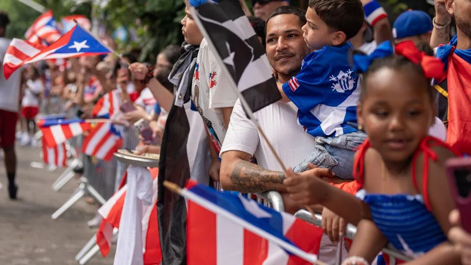 Festival-goers line up to watch the parade together in Bushwick. - David Dee Delgado for CNN