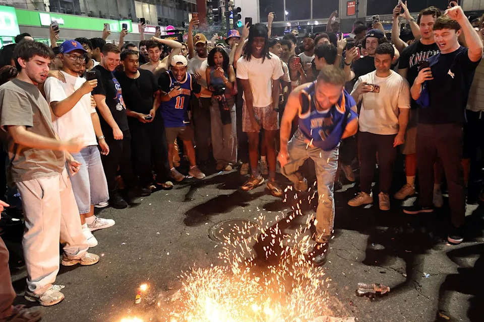 Crowds in N.Y.C. light fireworks after the Knicks' NBA title winCredit: Michael Heiman/Getty