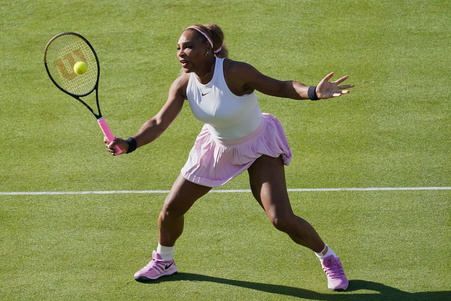 Serena Williams of the United States, hits a return as she and playing partner Victoria Mboko of Canada play against Nicole Melichar-Martinez of Canada and Erin Routliffe of New Zealand during their first round doubles match at the Queen's Club tennis championships in London, Tuesday, June 9, 2026.