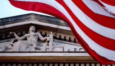 FILE - An American flag flies outside the Department of Justice in Washington, March 22, 2019. (AP Photo/Andrew Harnik, File)
