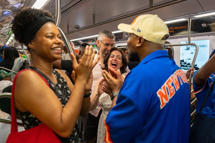 New Yorkers celebrate on the A train after the Knicks win on Saturday. (Photo by Jeremy Weine/Getty Images)