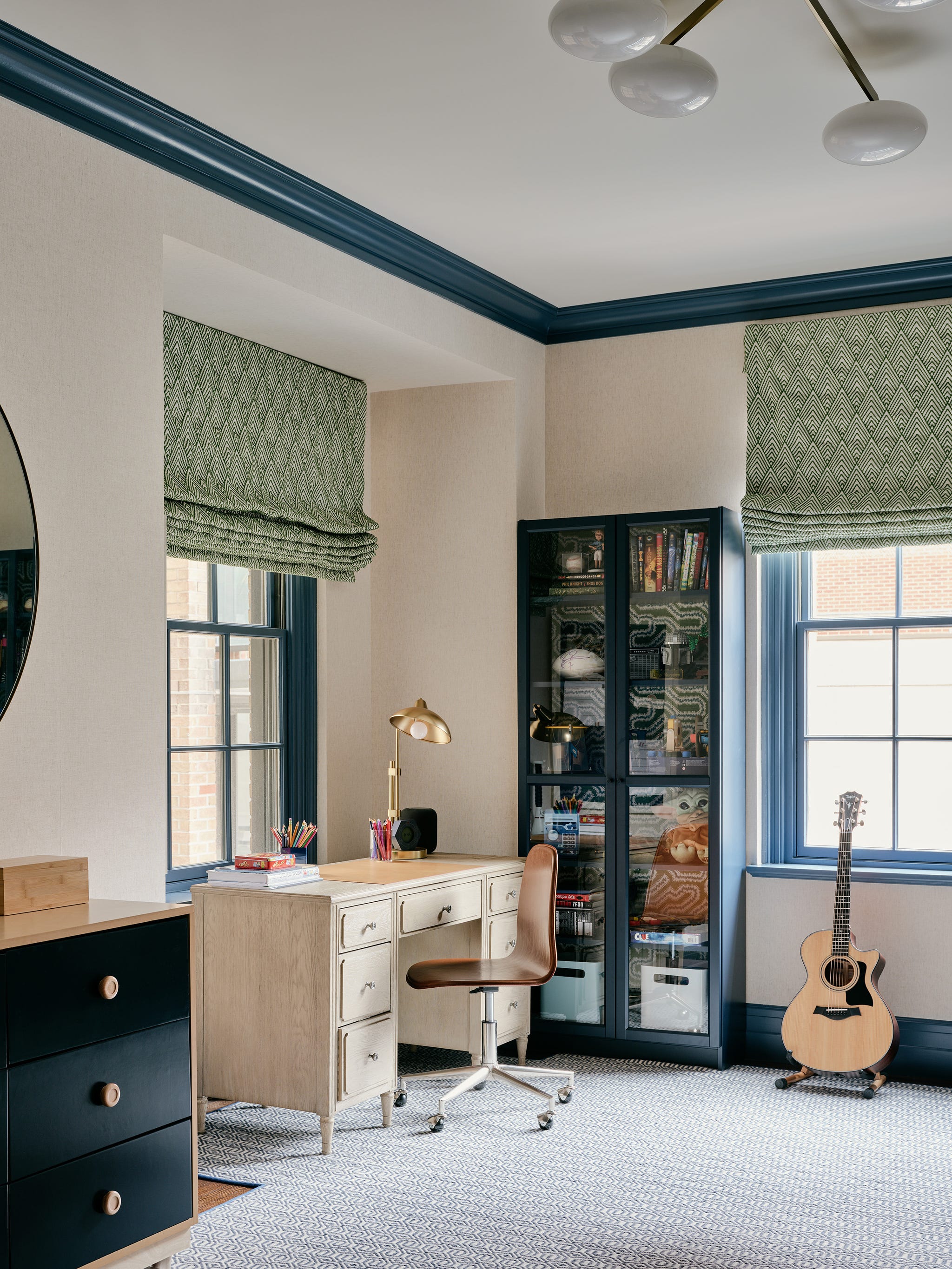 Cozy home office with a wooden desk, chair, and shelves next to a window.