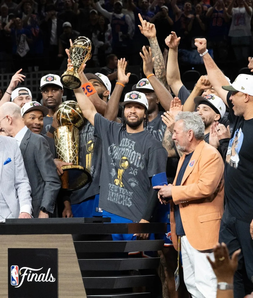 Knicks captain <a class="link " href="https://sports.yahoo.com/nba/players/6044/" data-i13n="sec:content-canvas;subsec:anchor_text;elm:context_link" data-ylk="slk:Jalen Brunson;sec:content-canvas;subsec:anchor_text;elm:context_link;itc:0" data-yga="{"yLinkElement":"context_link","yModuleName":"content-canvas","yLinkText":"Jalen Brunson","ySubModuleName":"anchor_text","yHasCommerce":false}">Jalen Brunson</a> holds up the MVP trophy next to owner James Dolan after winning the NBA Finals in <a class="link " href="https://sports.yahoo.com/nba/teams/san-antonio/" data-i13n="sec:content-canvas;subsec:anchor_text;elm:context_link" data-ylk="slk:San Antonio;sec:content-canvas;subsec:anchor_text;elm:context_link;itc:0" data-yga="{"yLinkElement":"context_link","yModuleName":"content-canvas","yLinkText":"San Antonio","ySubModuleName":"anchor_text","yHasCommerce":false}">San Antonio</a> on June 13, 2026. Charles Wenzelberg / New York Post