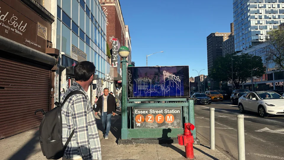 Man looking toward subway entrance