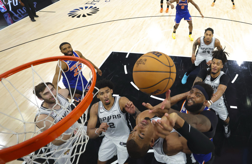 Jun 13, 2026; San Antonio, Texas, USA; New York Knicks center Mitchell Robinson (23) and San Antonio Spurs forward Victor Wembanyama (1) battle for the ball during game five of the 2026 NBA Finals at Frost Bank Center.