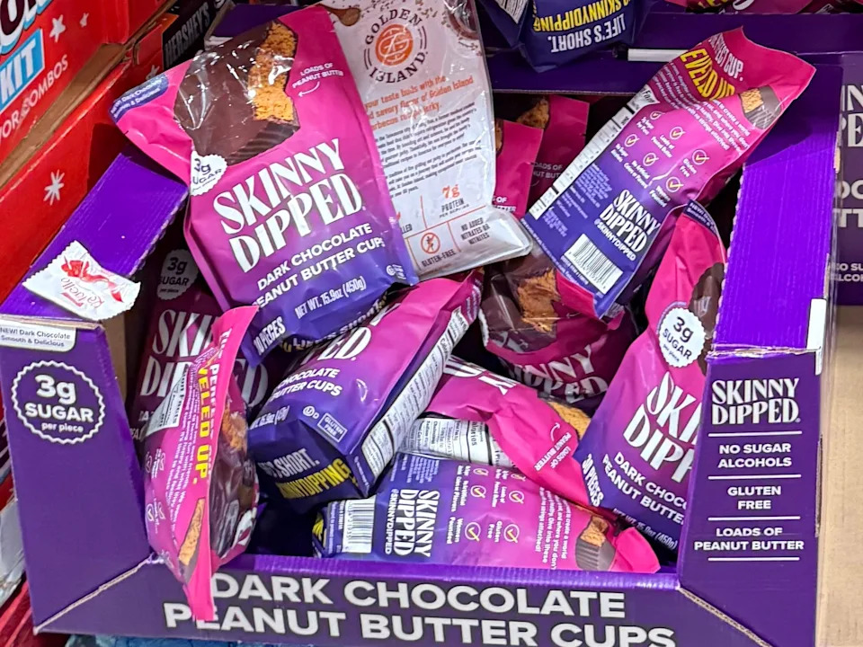 Multiple bags of the Skinny Dipped dark-chocolate peanut butter cups.