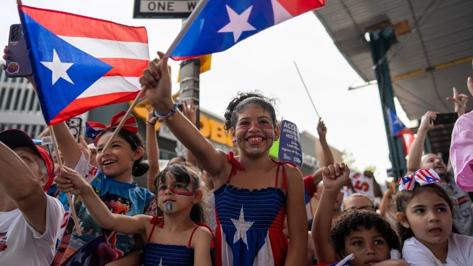 Children wave flags in the crowd in Bushwick. - David Dee Delgado for CNN