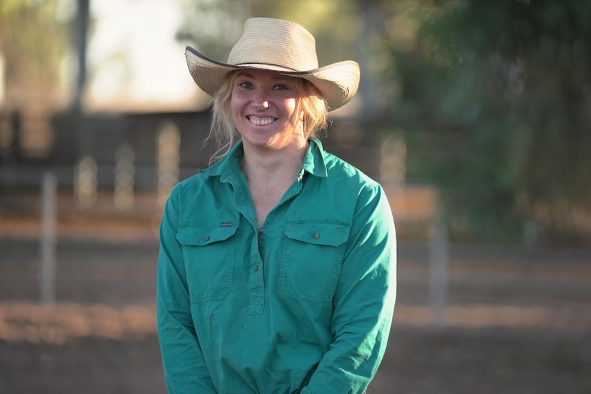A woman standing in front of a farm station.