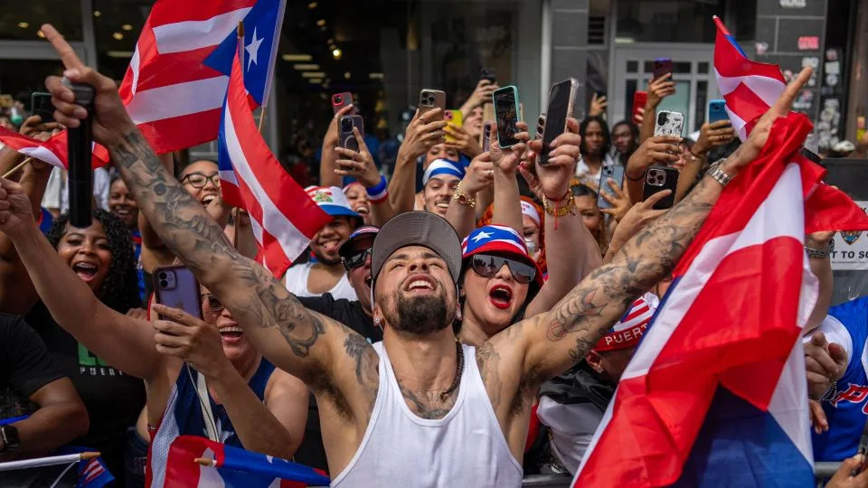 New York Knicks point guard Jose Alvarado poses with fans fresh off his NBA championship win. - David Dee Delgado for CNN