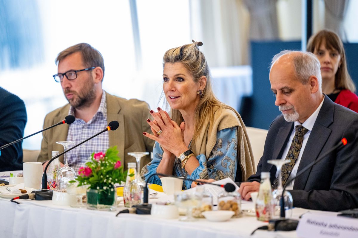 Queen Máxima refreshed a beloved wardrobe favorite with a coordinating scarf draped elegantly over one shoulder.