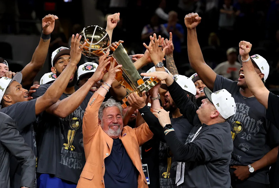 New York Knicks owner James Dolan and president Leon Rose lift the Larry O'Brien Championship Trophy.