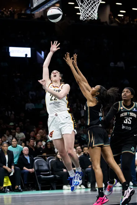 NEW YORK, NEW YORK - JUNE 6: Caitlin Clark #22 of the Indiana Fever makes a basket against Rebekah Gardner #7 of the New York Liberty at Barclays Center on June 6, 2026, in New York City. NOTE TO USER: User expressly acknowledges and agrees that, by downloading and/or using this Photograph, User is consenting to the terms and conditions of the Getty Images License Agreement. (Photo by Michelle Farsi/Getty Images)