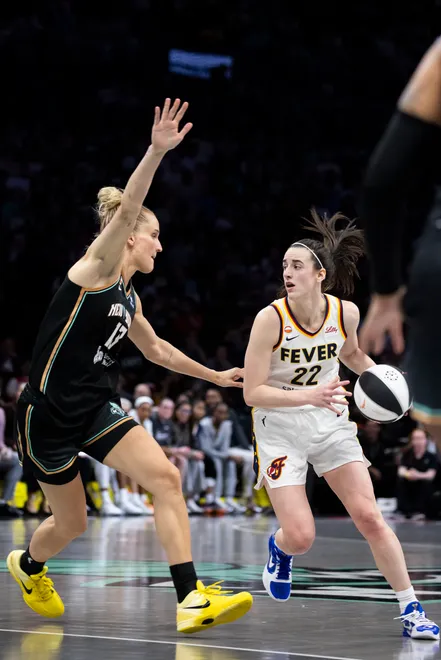 NEW YORK, NEW YORK - JUNE 6: Caitlin Clark #22 of the Indiana Fever handles the ball against Leonie Fiebich #13 of the New York Liberty at Barclays Center on June 6, 2026, in New York City. NOTE TO USER: User expressly acknowledges and agrees that, by downloading and/or using this Photograph, User is consenting to the terms and conditions of the Getty Images License Agreement. (Photo by Michelle Farsi/Getty Images)