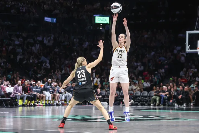 Jun 6, 2026; Brooklyn, New York, USA; Indiana Fever guard Caitlin Clark (22) shoots past New York Liberty guard Marine Johannès (23) in the third quarter at Barclays Center. Mandatory Credit: Wendell Cruz-Imagn Images