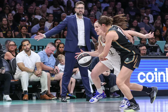 Jun 6, 2026; Brooklyn, New York, USA; Indiana Fever guard Caitlin Clark (22) looks to drive past New York Liberty guard Pauline Astier (18) in the third quarter at Barclays Center. Mandatory Credit: Wendell Cruz-Imagn Images