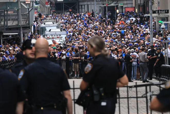 NEW YORK, NEW YORK - JUNE 18: Thousands of fans crowd into lower Manhattan near Wall Street before the New York Knicks Championship ticker tape parade and victory rally celebrating winning the 2026 NBA Finals on June 18, 2026 in New York City. The New York Knicks defeated the San Antonio Spurs in five games to win their first NBA Championship in 53 years.