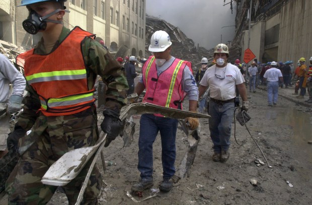 Emergency crews and construction workers search the wreckage of the World Trade Center on September 12, 2001.